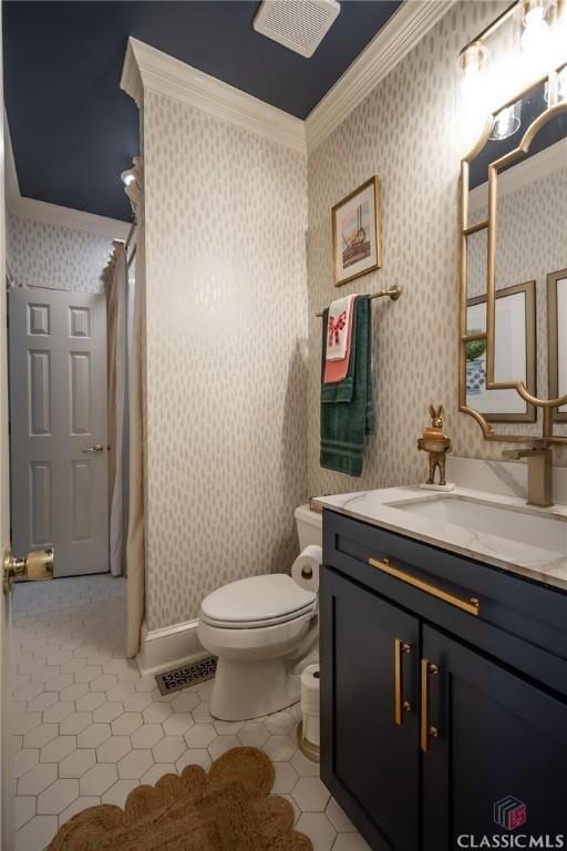 bathroom with tile patterned floors, ornamental molding, toilet, and vanity