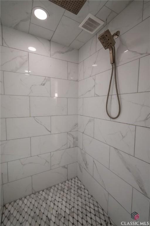 bathroom with tiled shower