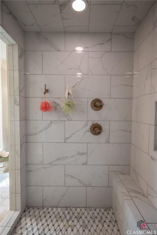 bathroom with tiled shower