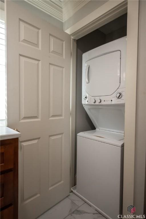 washroom featuring stacked washer and dryer