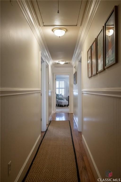 hall with hardwood / wood-style floors and crown molding