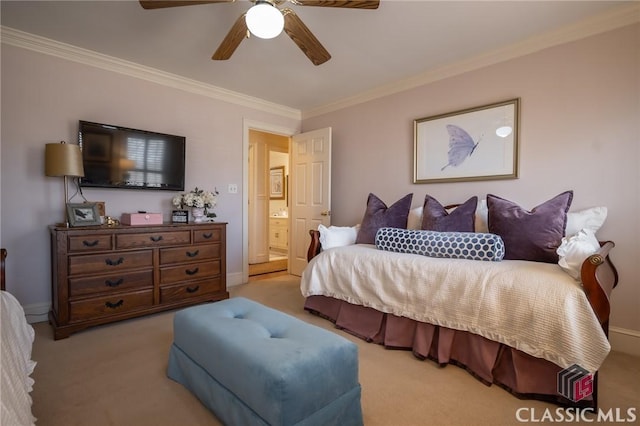 bedroom featuring light colored carpet, ornamental molding, and ensuite bath