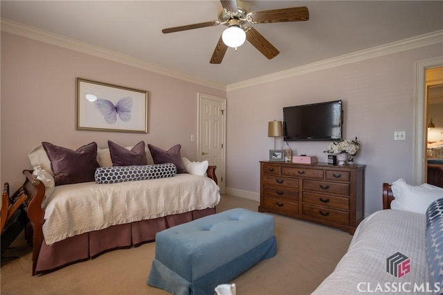 carpeted bedroom featuring ornamental molding and ceiling fan