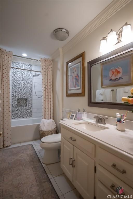 full bathroom with shower / tub combo with curtain, toilet, crown molding, vanity, and tile patterned flooring