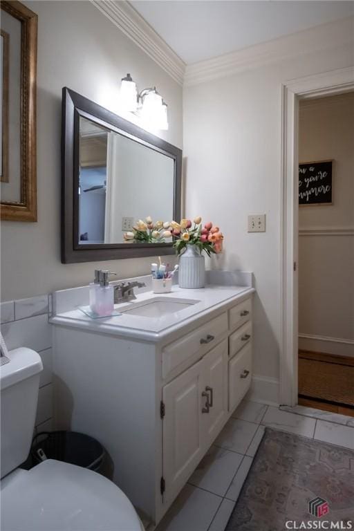 bathroom featuring vanity, crown molding, and toilet