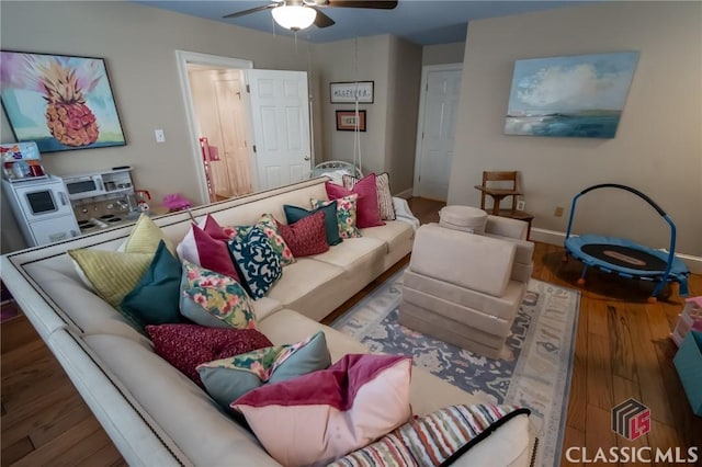 living room featuring ceiling fan and wood-type flooring