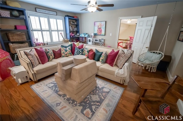 living room featuring wood-type flooring and ceiling fan