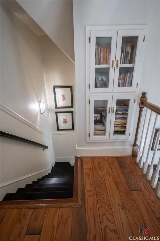 staircase featuring wood-type flooring