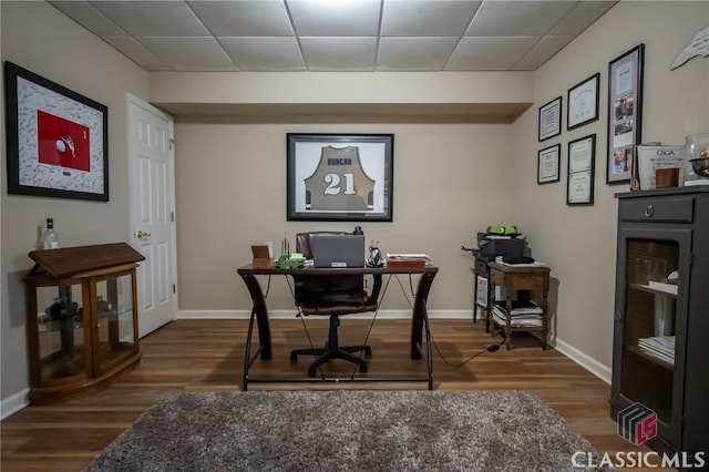 office with wine cooler, a paneled ceiling, and hardwood / wood-style floors