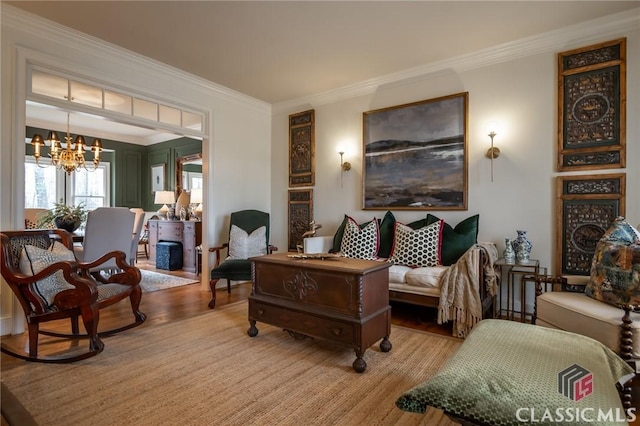 sitting room featuring crown molding, a chandelier, and light hardwood / wood-style floors