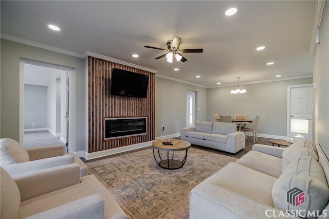 living room featuring crown molding, ceiling fan with notable chandelier, and light wood-type flooring