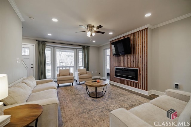 living room with ceiling fan, ornamental molding, and wood-type flooring