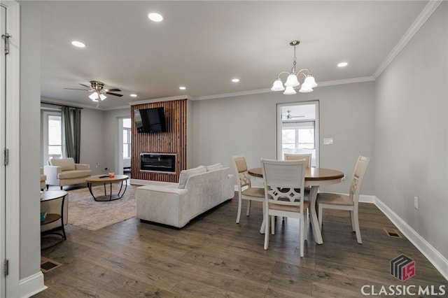 dining room with crown molding, ceiling fan, and dark hardwood / wood-style flooring