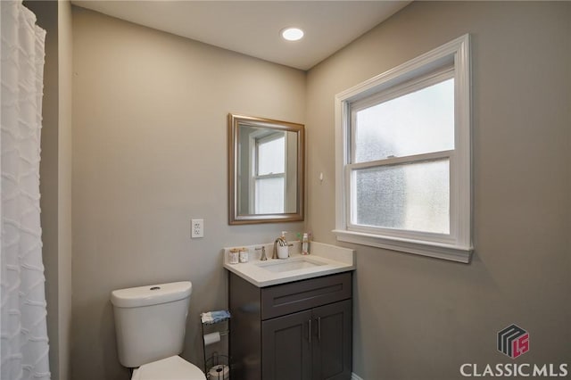 bathroom featuring vanity and toilet