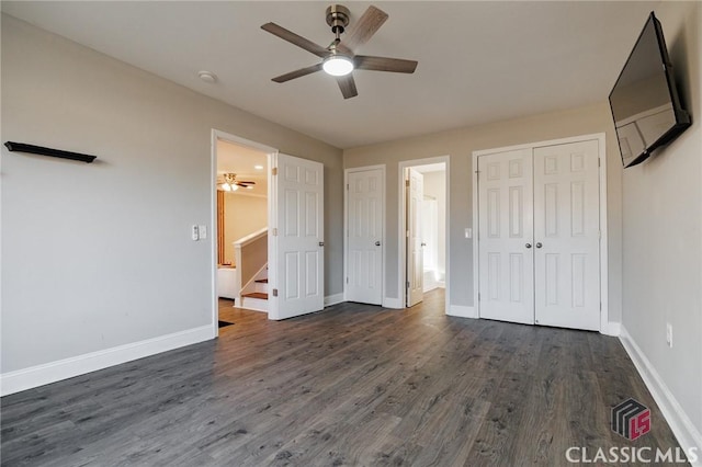 unfurnished bedroom featuring ceiling fan and dark hardwood / wood-style floors