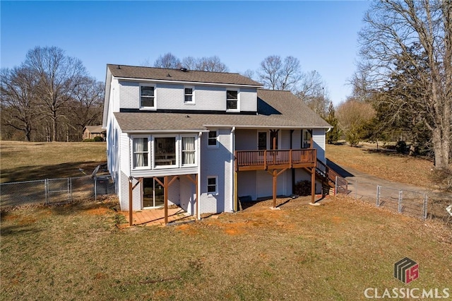 back of property featuring a yard and a deck