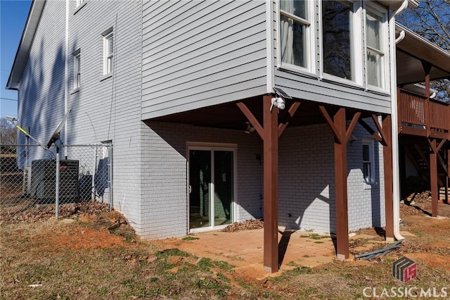 view of home's exterior with central AC unit and a deck