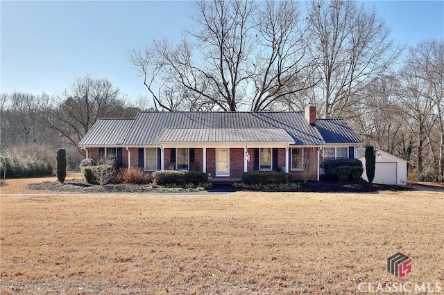 ranch-style house with a garage, a porch, an outbuilding, and a front yard