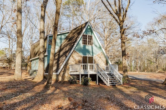 rear view of house featuring a wooden deck