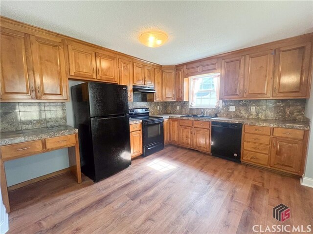 kitchen featuring light hardwood / wood-style flooring, ceiling fan, dishwasher, a textured ceiling, and decorative backsplash