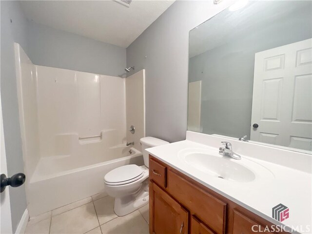 full bathroom with vanity, tub / shower combination, tile patterned floors, and toilet