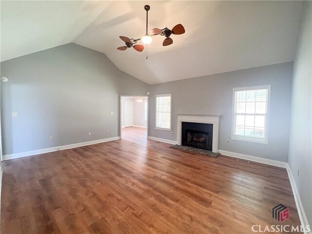 unfurnished living room featuring hardwood / wood-style flooring, ceiling fan, and vaulted ceiling