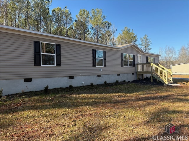 view of side of home featuring a yard