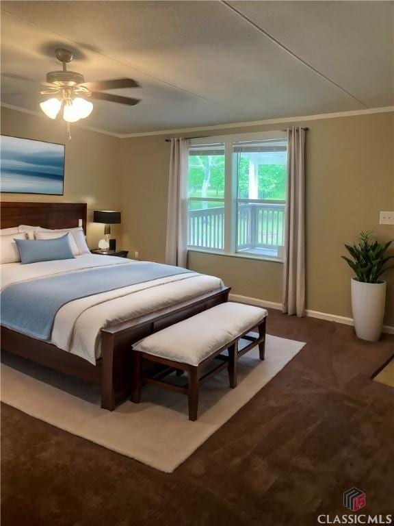 bedroom featuring ceiling fan, ornamental molding, and dark colored carpet