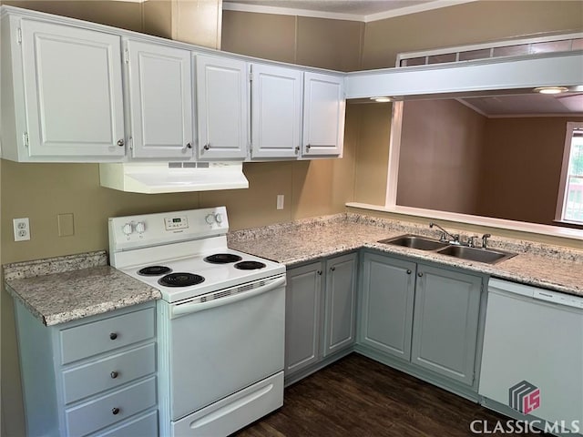 kitchen with white appliances, sink, and white cabinets