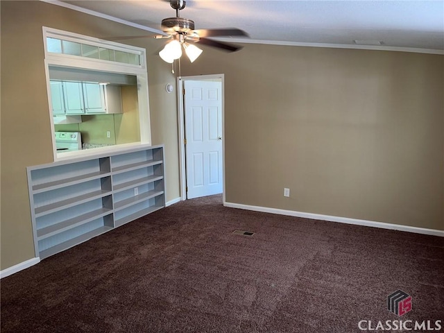 spare room featuring crown molding, ceiling fan, and carpet