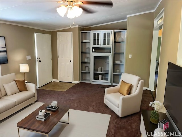 living room with crown molding, ceiling fan, and dark carpet