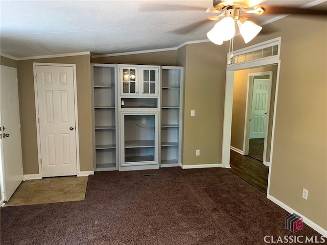 unfurnished living room with lofted ceiling, crown molding, and dark colored carpet