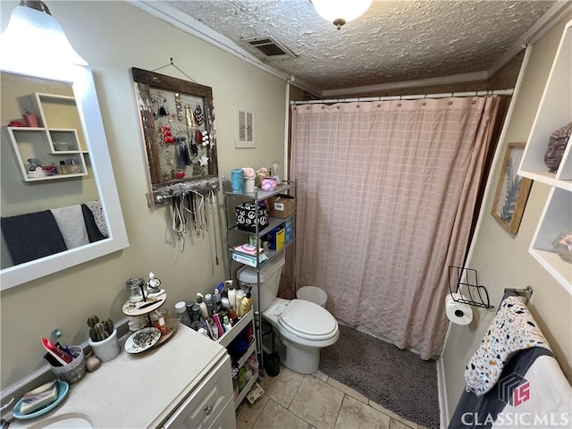 bathroom featuring tile patterned floors, toilet, a textured ceiling, and walk in shower