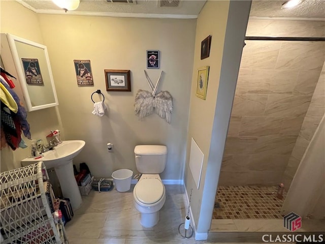 bathroom featuring tiled shower and toilet