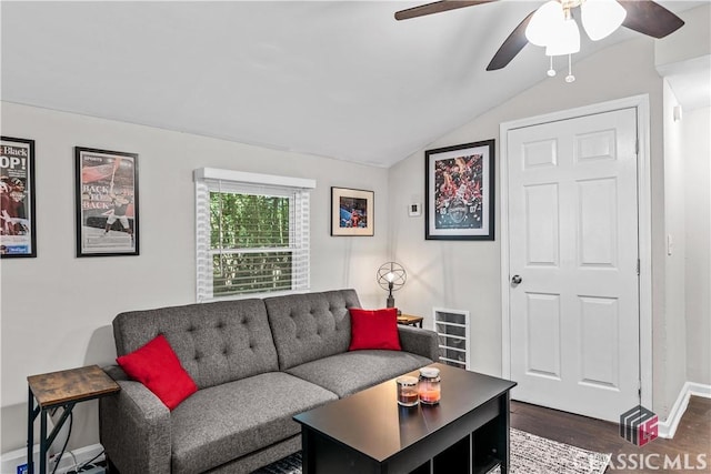 living room featuring lofted ceiling, dark wood-type flooring, and ceiling fan