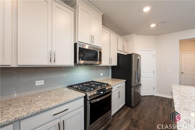 kitchen featuring white cabinetry, light stone counters, tasteful backsplash, and stainless steel appliances