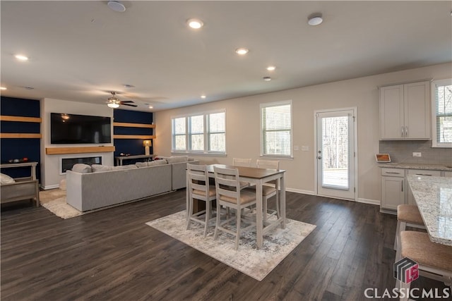 dining room featuring dark hardwood / wood-style flooring and ceiling fan