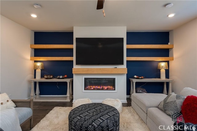 living room featuring hardwood / wood-style flooring and ceiling fan