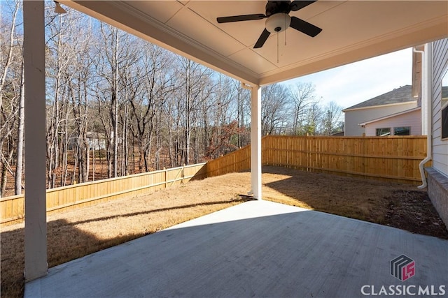 view of yard with ceiling fan and a patio