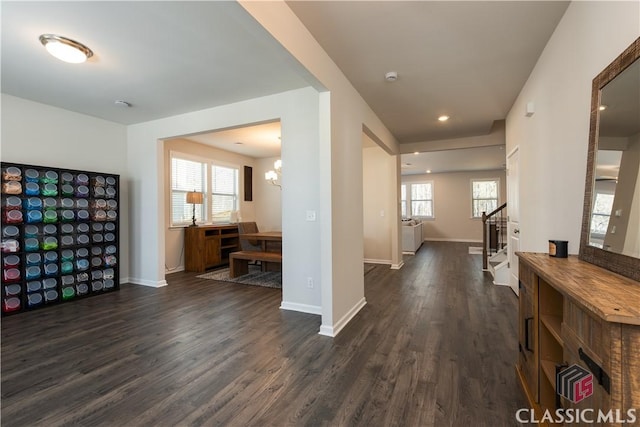 interior space featuring dark wood-type flooring and a chandelier