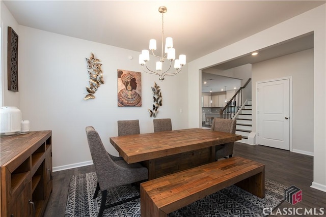 dining space featuring a chandelier and dark hardwood / wood-style flooring