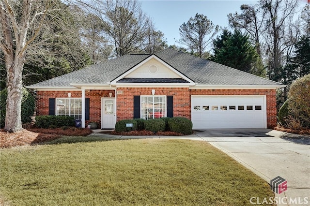 view of front of house with a garage and a front yard