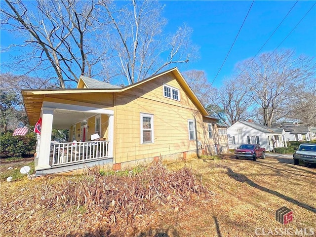 view of property exterior with a porch