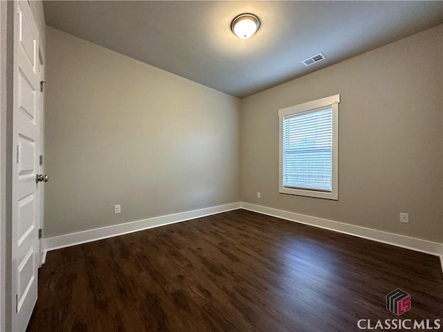 empty room featuring dark hardwood / wood-style floors