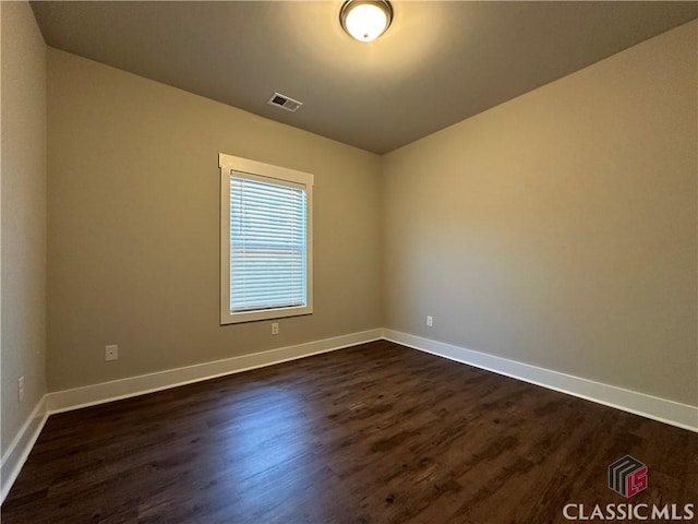 unfurnished room featuring dark wood-type flooring