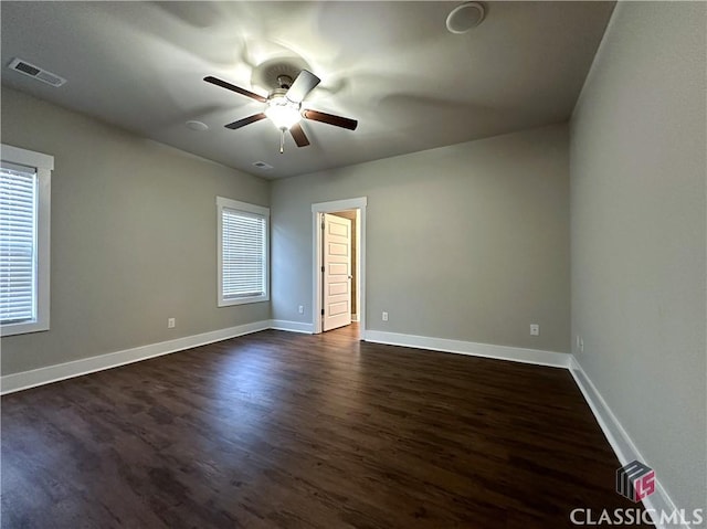 spare room featuring ceiling fan and dark hardwood / wood-style floors