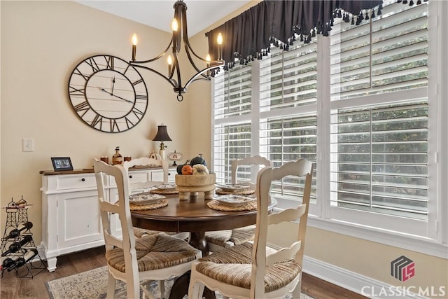 dining room featuring dark hardwood / wood-style flooring and a chandelier