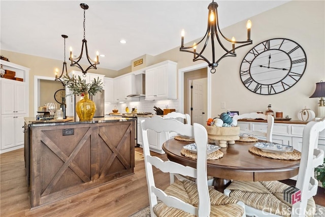 dining room with a chandelier and light hardwood / wood-style floors