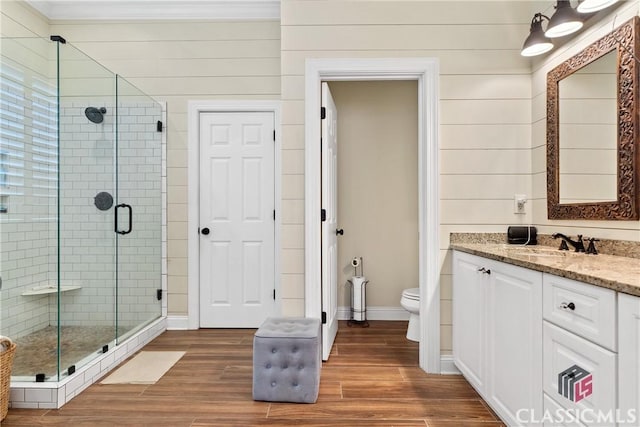 bathroom with vanity, an enclosed shower, wood-type flooring, and toilet