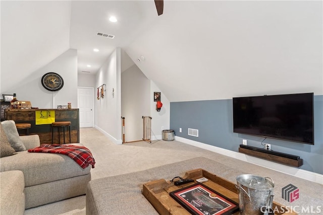 carpeted living room with lofted ceiling